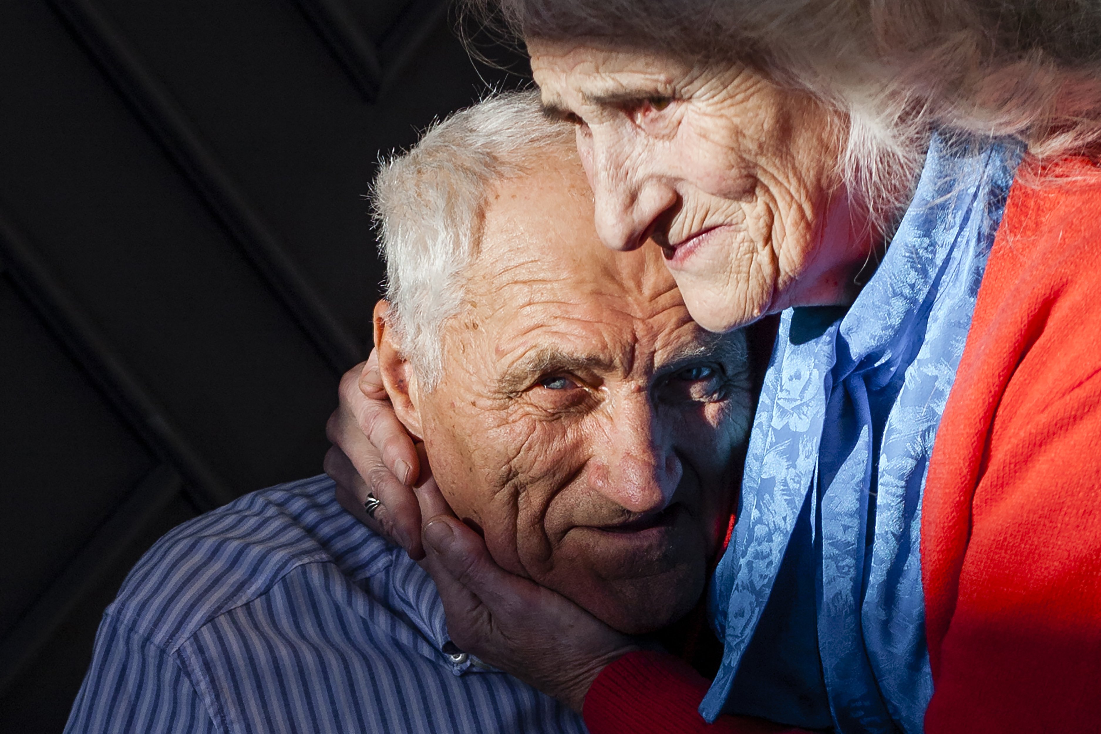 Senior couple embracing at home